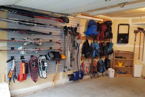A neatly organized garage with all kinds of outdoor gear that's easily accessible