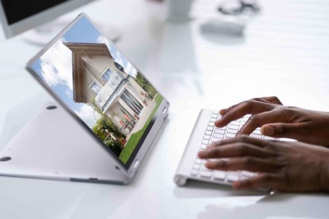 Hands on a keyboard looking at a 360 virtual tour online