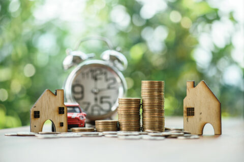 clocks, money and houses to demonstrate buying and selling at the same time