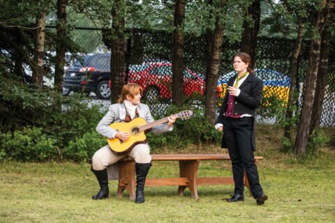 Actors from Pine Tree Players perform a scene outside
