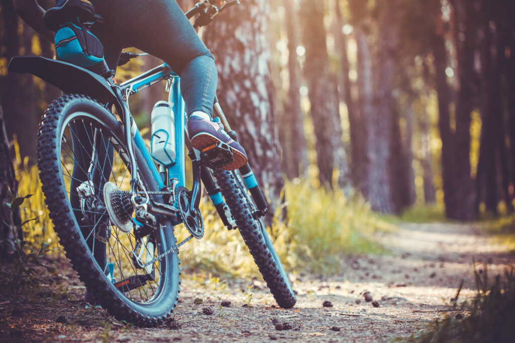 Mountain biker on a trail off to the side using correct trail etiquette