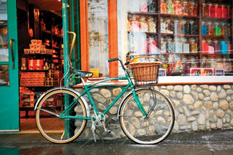 A local bike rests on a shop front in Banff
